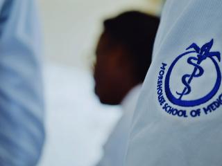 a close up of the Ҵý School of Medicine logo on a whitecoat