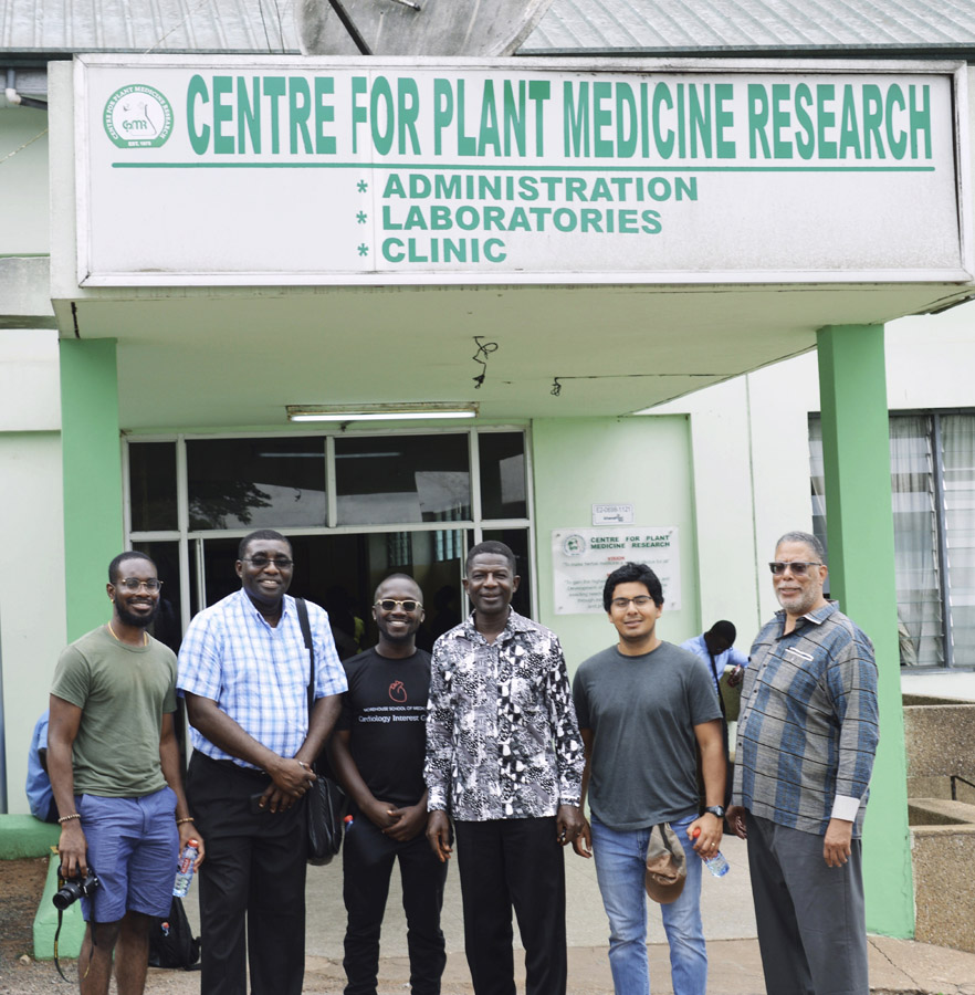 a group stand in front of the Centre for Plant Medicine Research building
